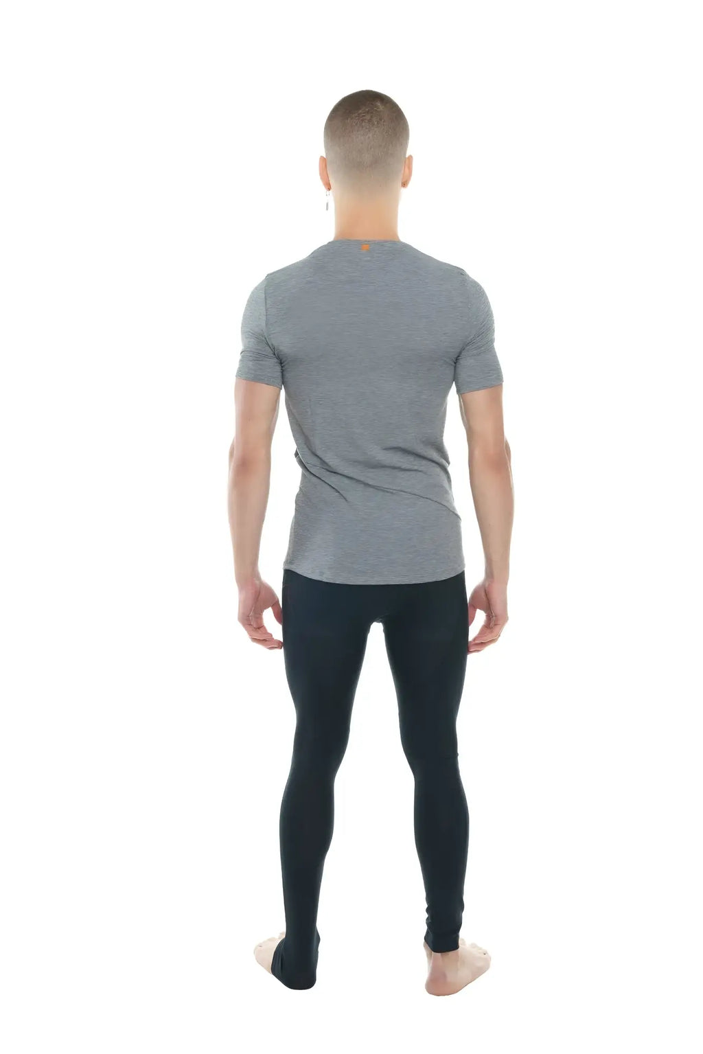 A man wearing a steel heather perfect pocket crew-neck tee with short sleeves and black leggings