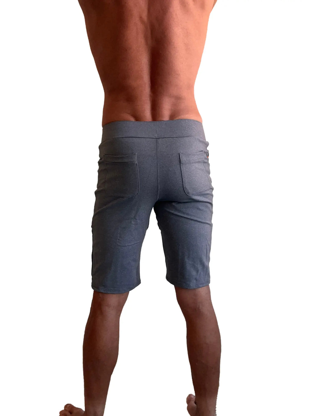Back view of performance premium urban tactical dress shorts in dark heather grey with elastic waistband and two rear pockets