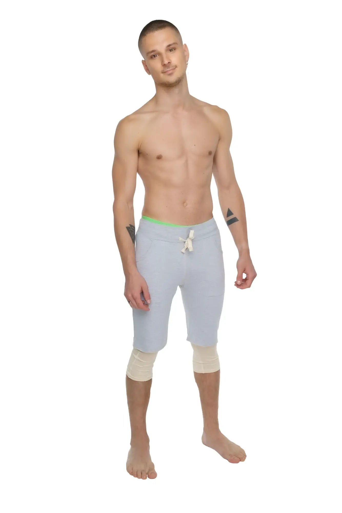Performance yoga leggings 3/4 in sand beige with light gray athletic shorts featuring neon green waistband and white drawstring