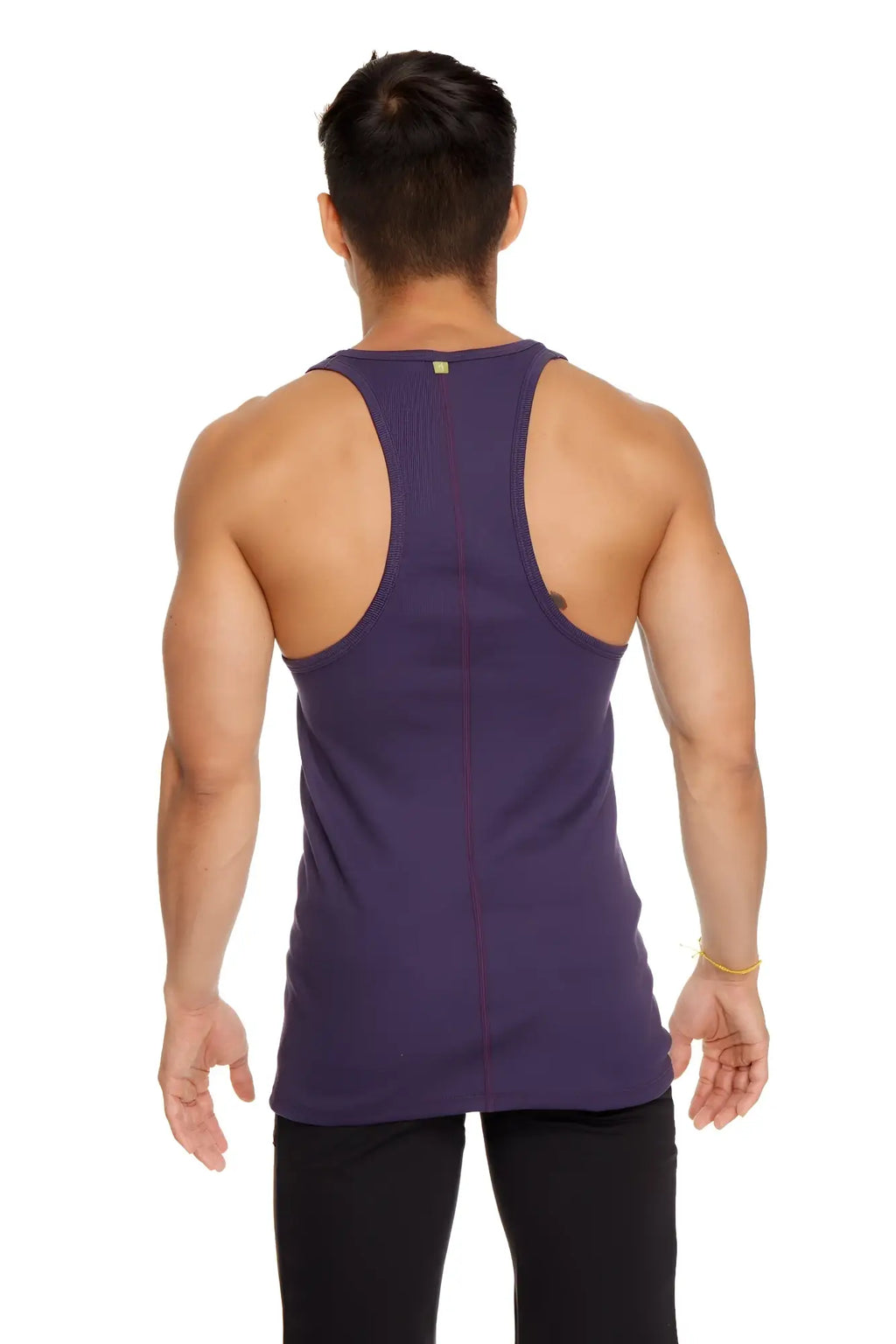 A deep purple racer-back yoga tank with a form-fitting design and subtle vertical seam detailing