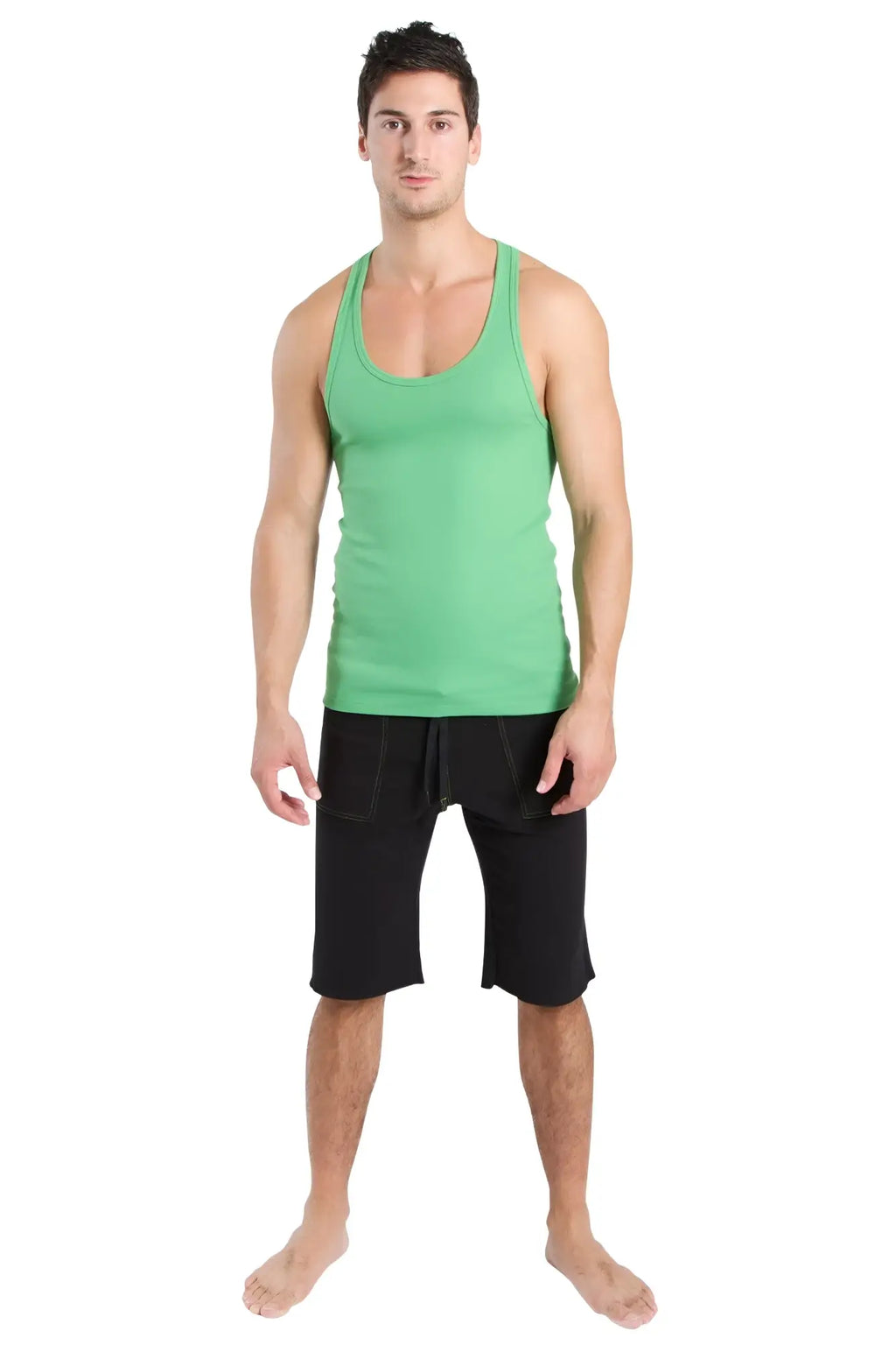 A man wearing a bamboo green racerback yoga tank top with a rounded neckline and black shorts with side pockets