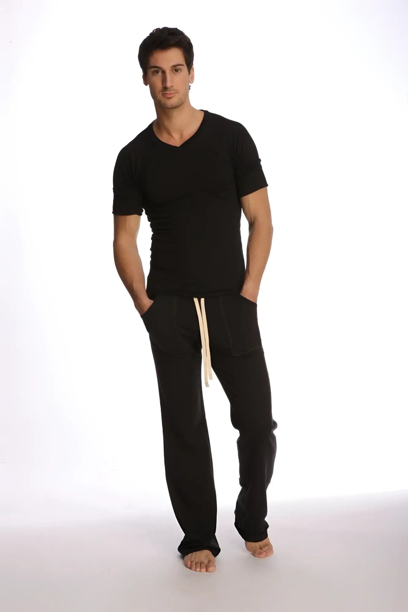 Black cotton joggers with cream-colored drawstrings paired with a raglan virtual crew neck in black