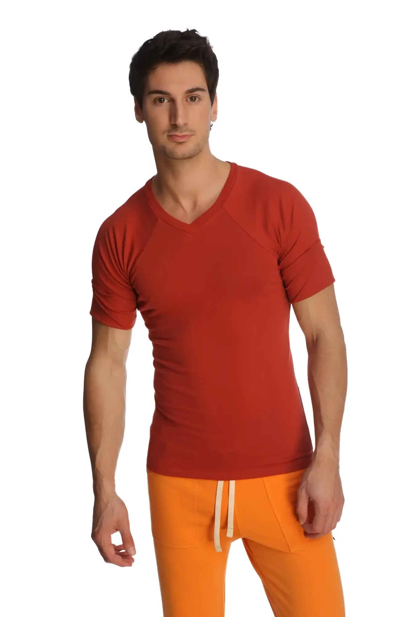 A man wearing a vibrant red short-sleeved v-neck raglan virtual crew neck t-shirt with subtle seam detailing