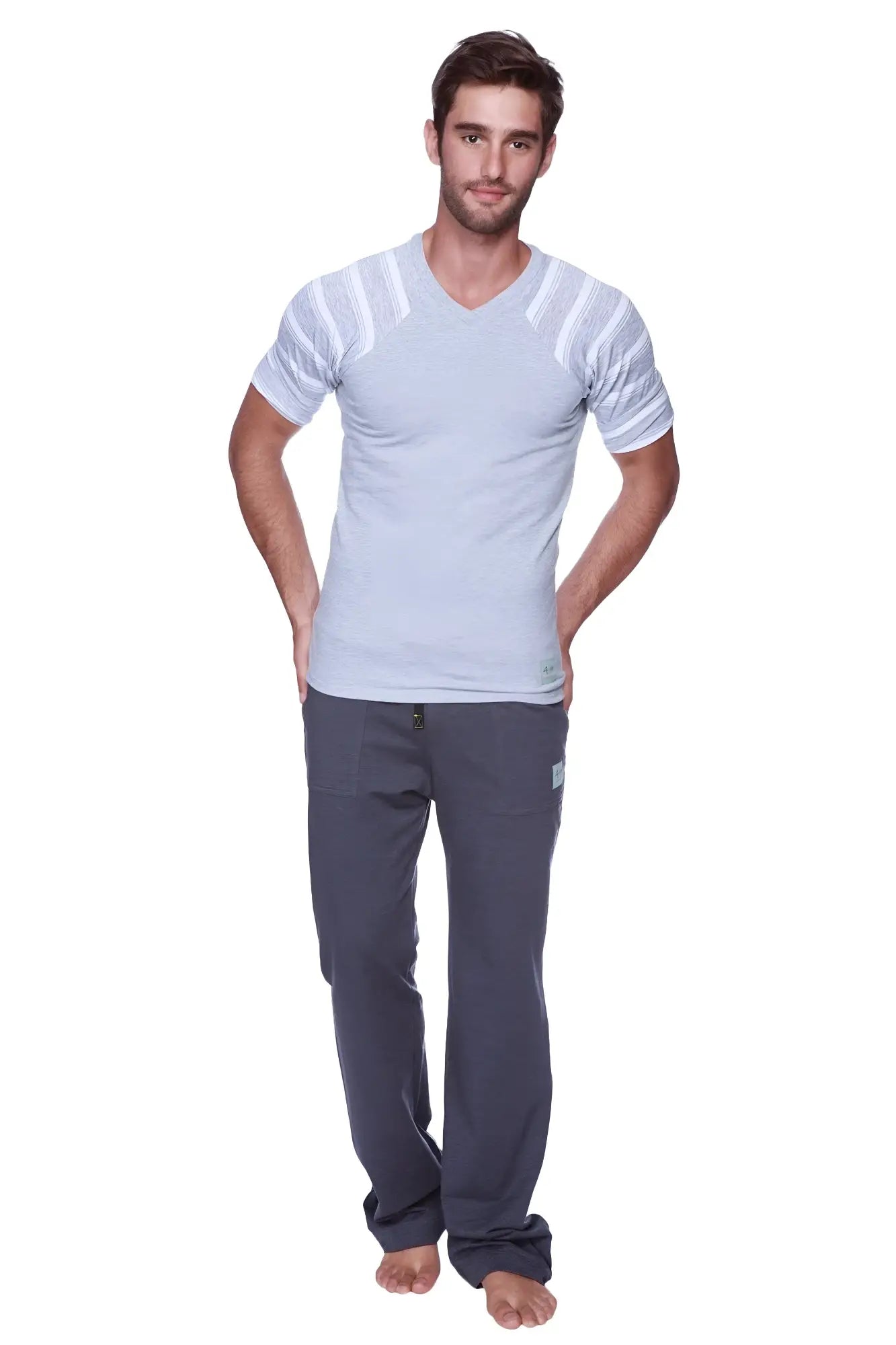 A man wearing a grey raglan virtual crew neck t-shirt with grey and white stripes and dark grey relaxed-fit pants