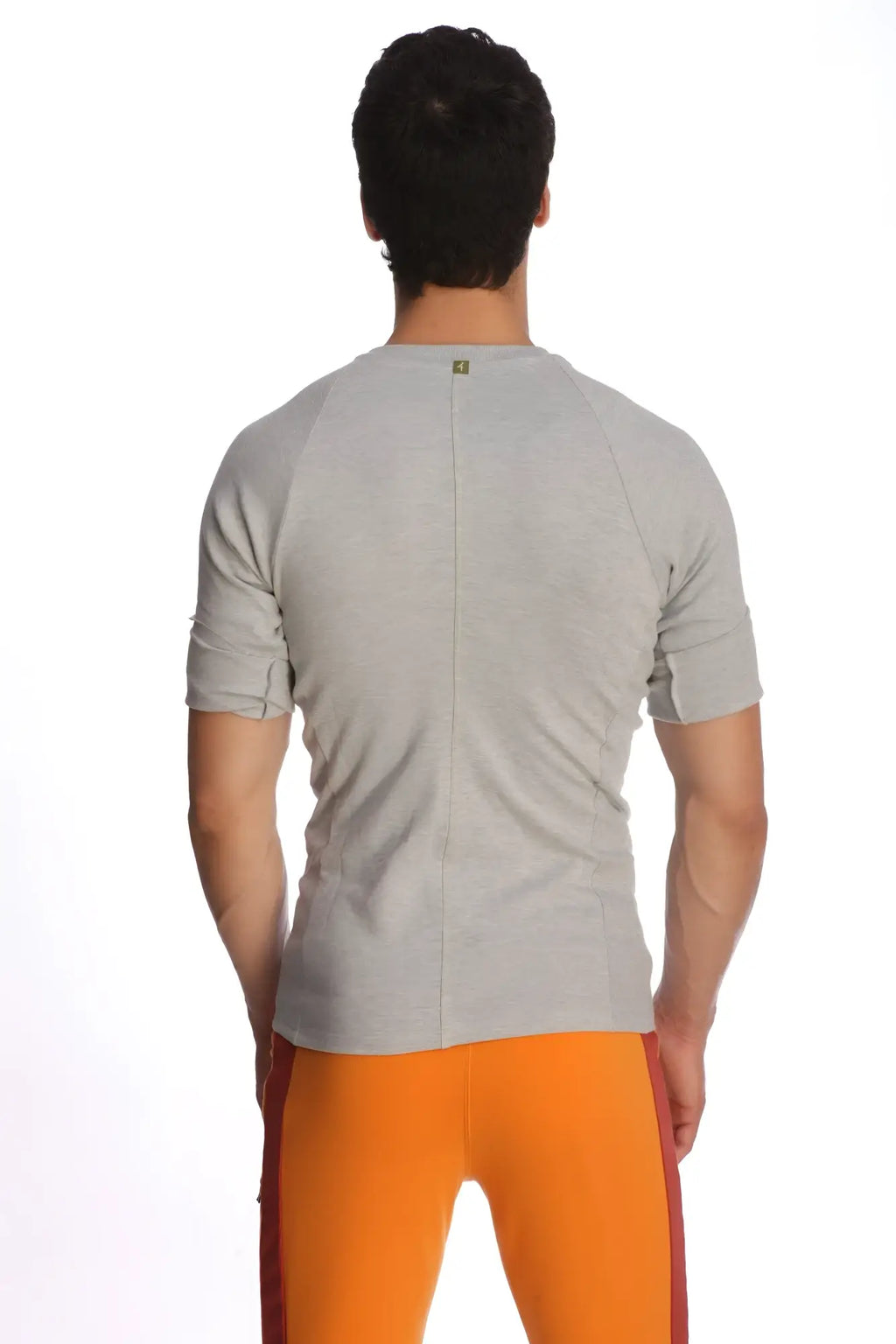Back view of a raglan virtual crew neck short-sleeved athletic shirt in heather grey with a central seam down the back