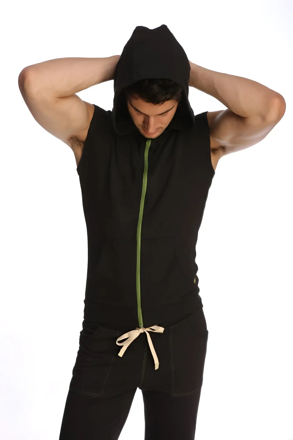 Black sleeveless yoga hoodie with green zipper and beige drawstring at the waist for comfortable workouts