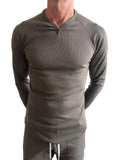 A sleek olive green thermal v neck long sleeve shirt with ribbed fabric and fitted design for layering or casual wear