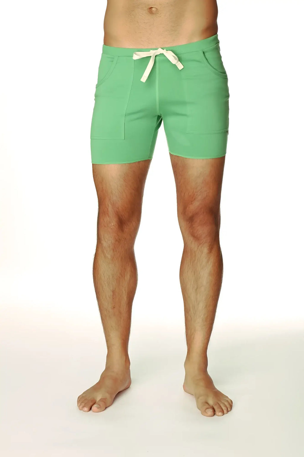 Transition yoga short in bamboo green with mint green drawstring, cream tie, and two front pockets for comfort