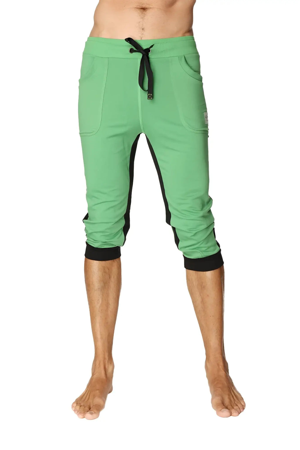Green ultra-flex tri-color cuffed yoga pant with black side panels elastic cuffs and capri-length joggers style
