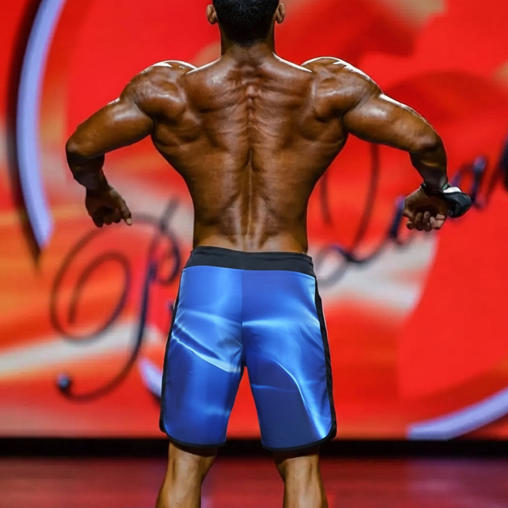 Blue MetroMaleWear MetroMuscleWear IFBB Pro mens physique board shorts with glossy finish and black trim sides and waistband