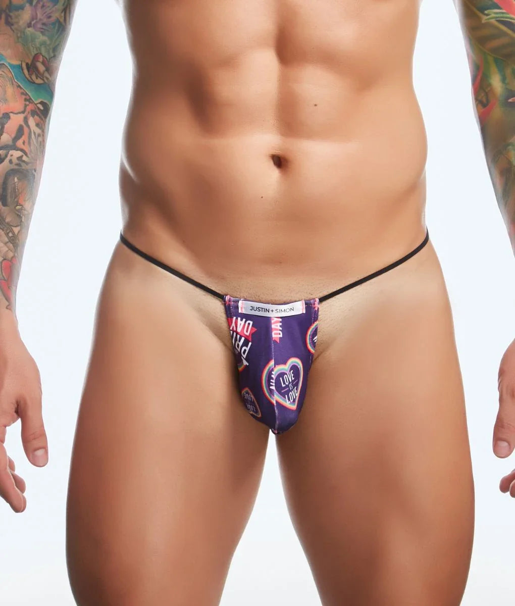 Purple patterned thong with black elastic waistband and heart design featuring justin kimmel branding from justin simon classic g-string bulge fun prints