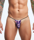 Purple patterned thong with black elastic waistband and heart design featuring justin kimmel branding from justin simon classic g-string bulge fun prints