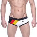 White swim trunks with black trim and german flag design on the side featuring ammy brand name metroMalewear
