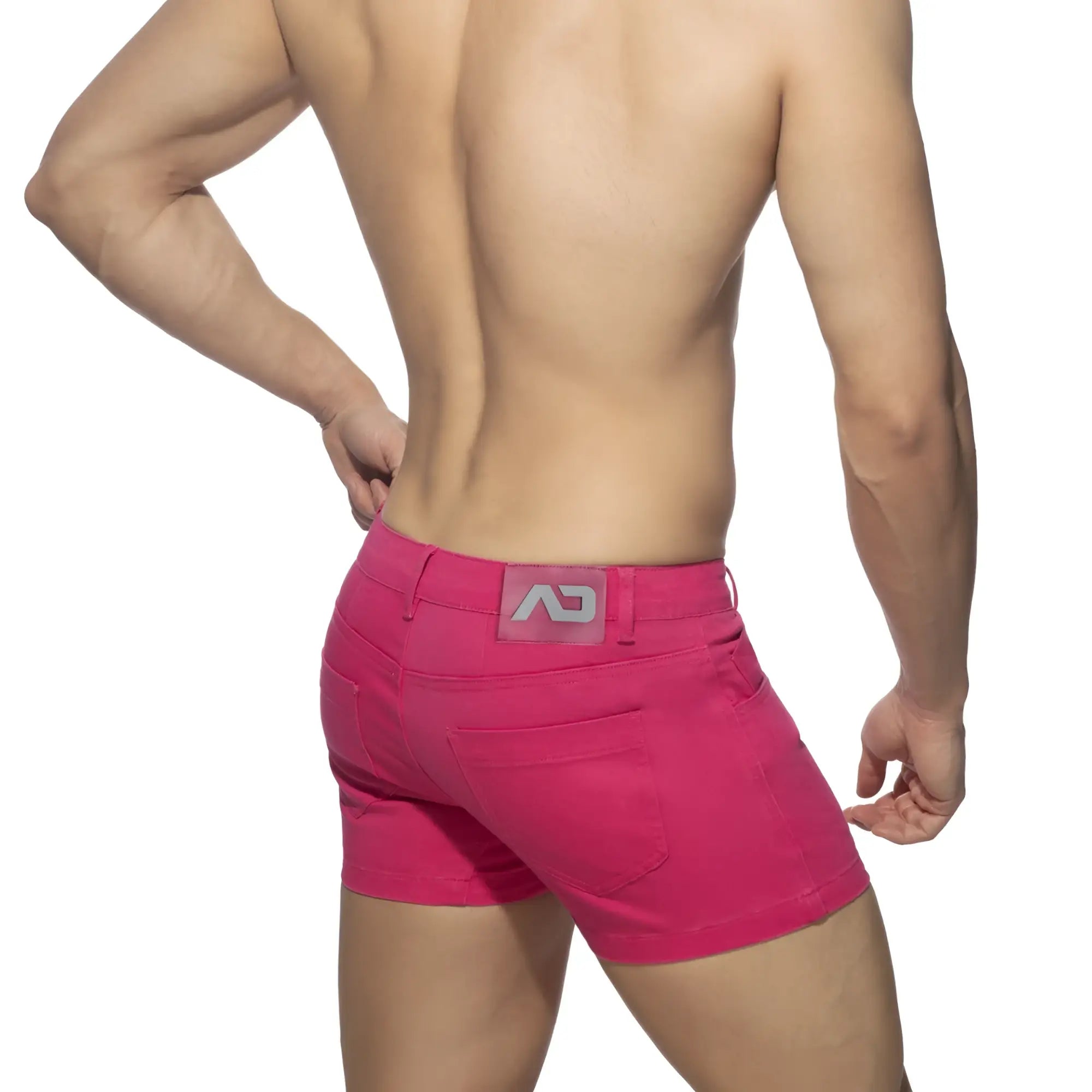 Bright pink 5 pockets summer shorts showing the back with a gray logo patch on the waistband