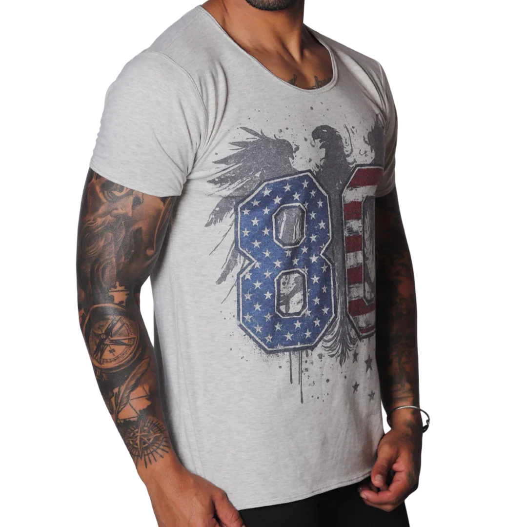 Light grey, raw-edge scoop neck t-shirt featuring a distressed eagle graphic with US flag-patterned "80" text.