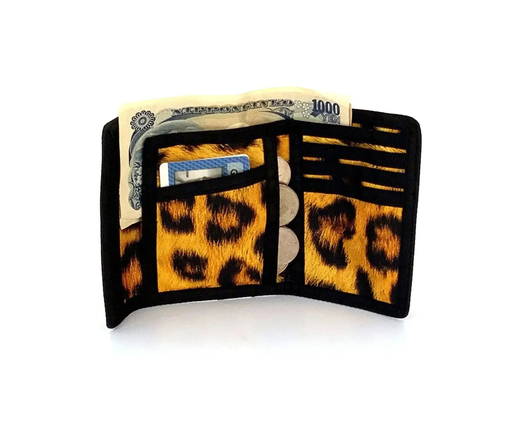An 80s velcro wallet with black and gold leopard print and a textured faux-fur finish tri-fold design