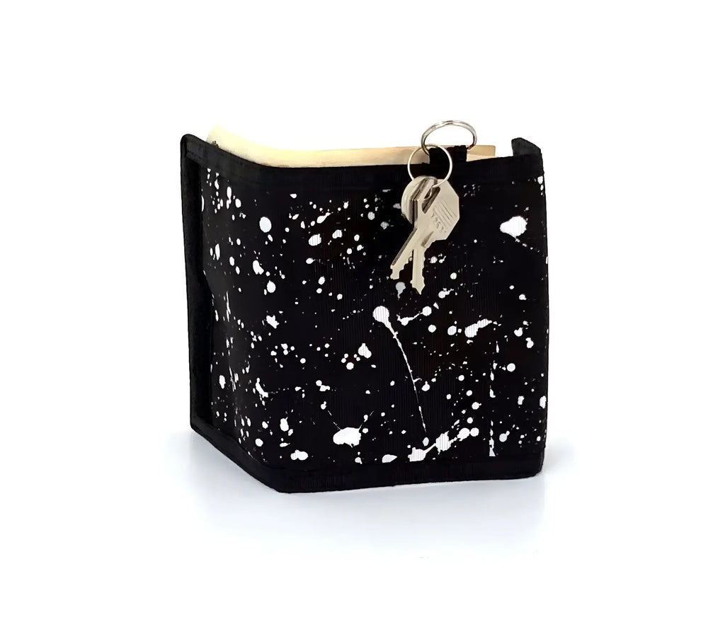 Black 80s veclro wallet with white paint splatter design and attached key ring with keys