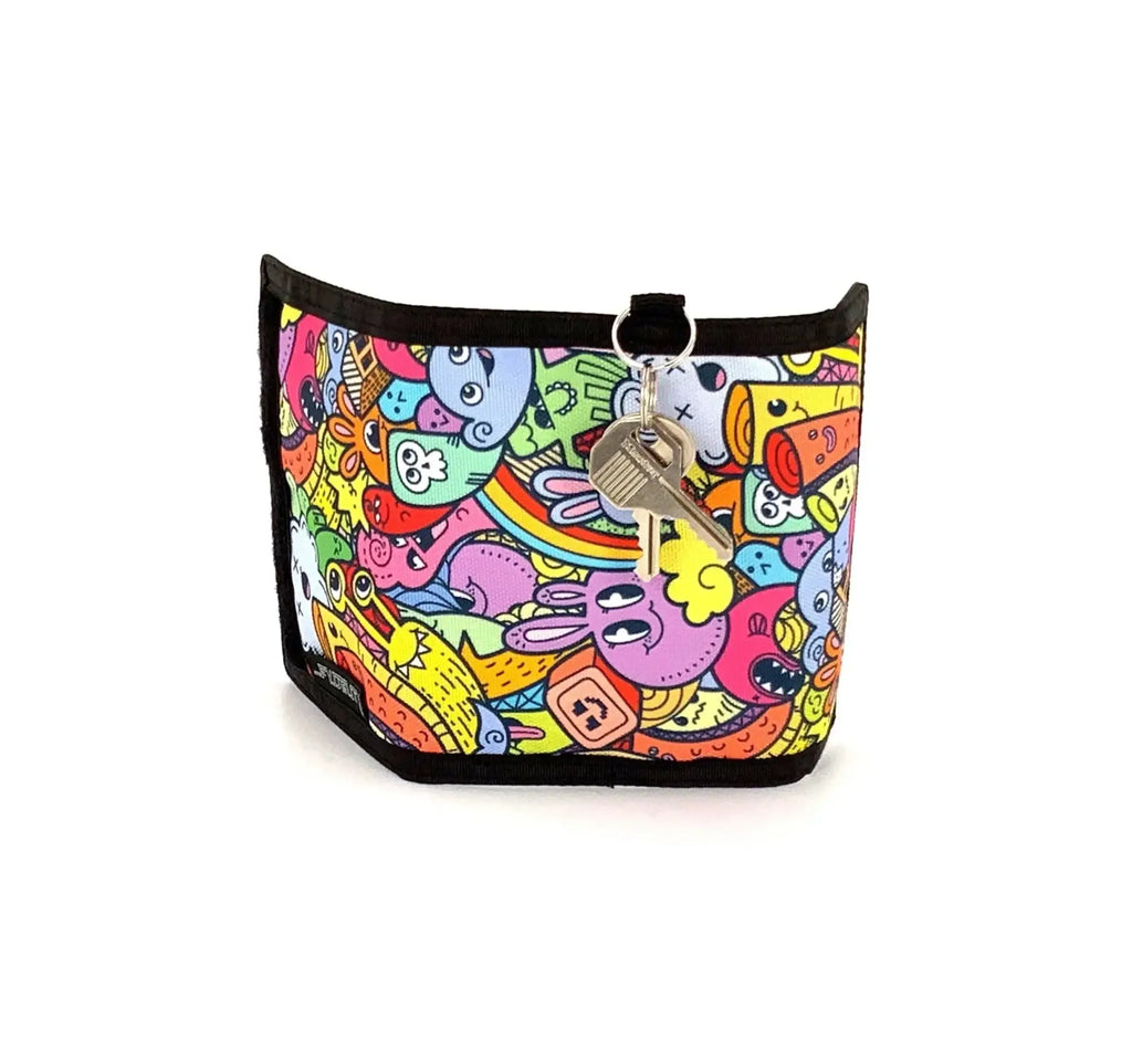 A colorful cartoon-patterned neoprene key holder with black trim and silver metal ring from 80s veclro wallet collection