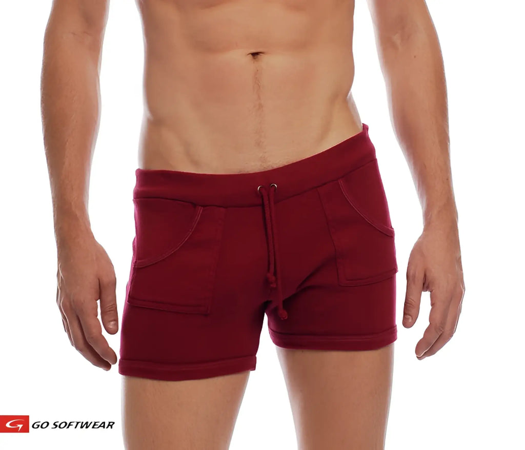 9 inch maroon sport shorts with drawstring waistband and two front pockets made from soft fabric for athletic use