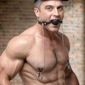 Strict Silicone Ball Gag with Nipple Clamps featuring a black silicone ball, leather strap, and silver metal chains.