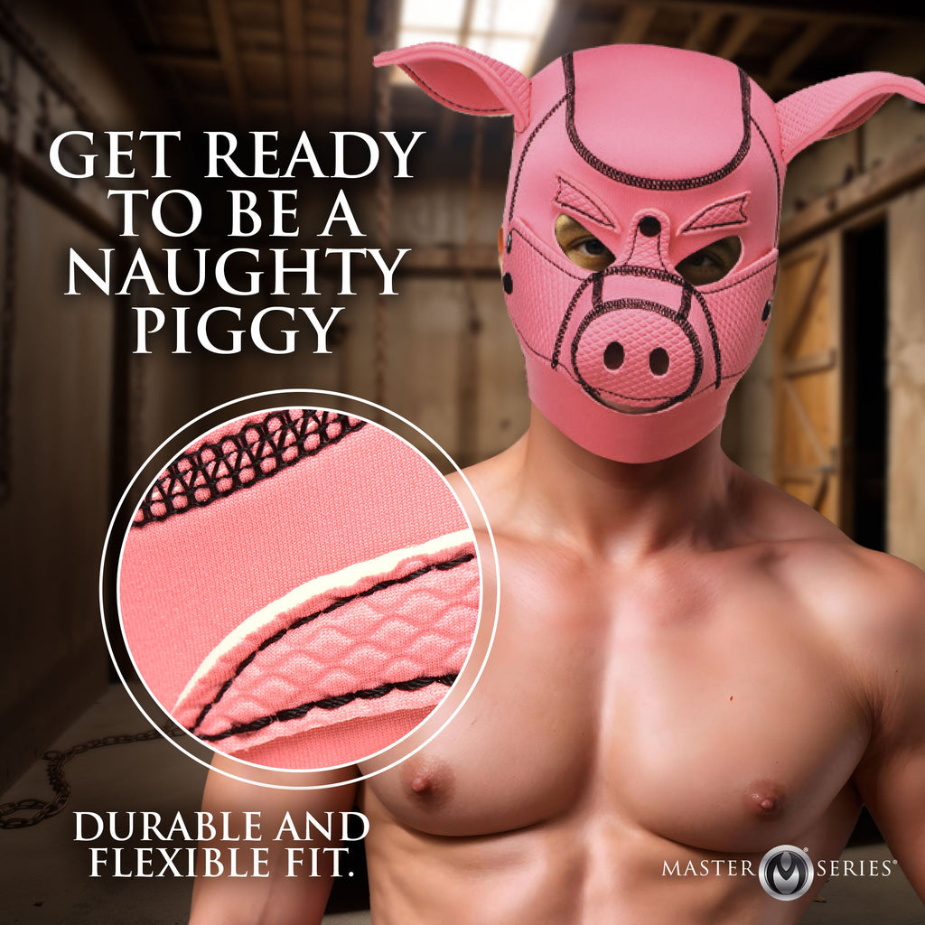 A shirtless man wears a pink neoprene Master Series Swine Pig hood with black stitching and prominent pig ears.