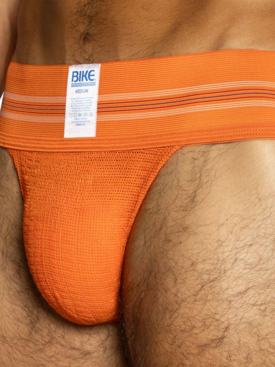 Orange BIKE athletic jockstrap, men's medium size, with textured pouch.