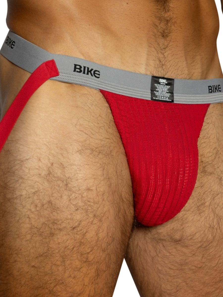 Red BIKE athletic jockstrap with a grey waistband and red fabric pouch.