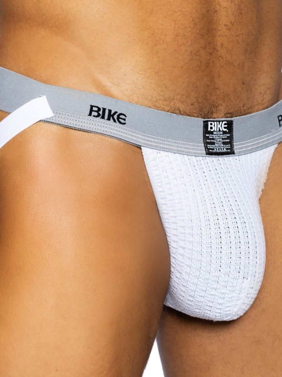 Close-up of white BIKE athletic jockstrap with textured pouch and grey waistband.