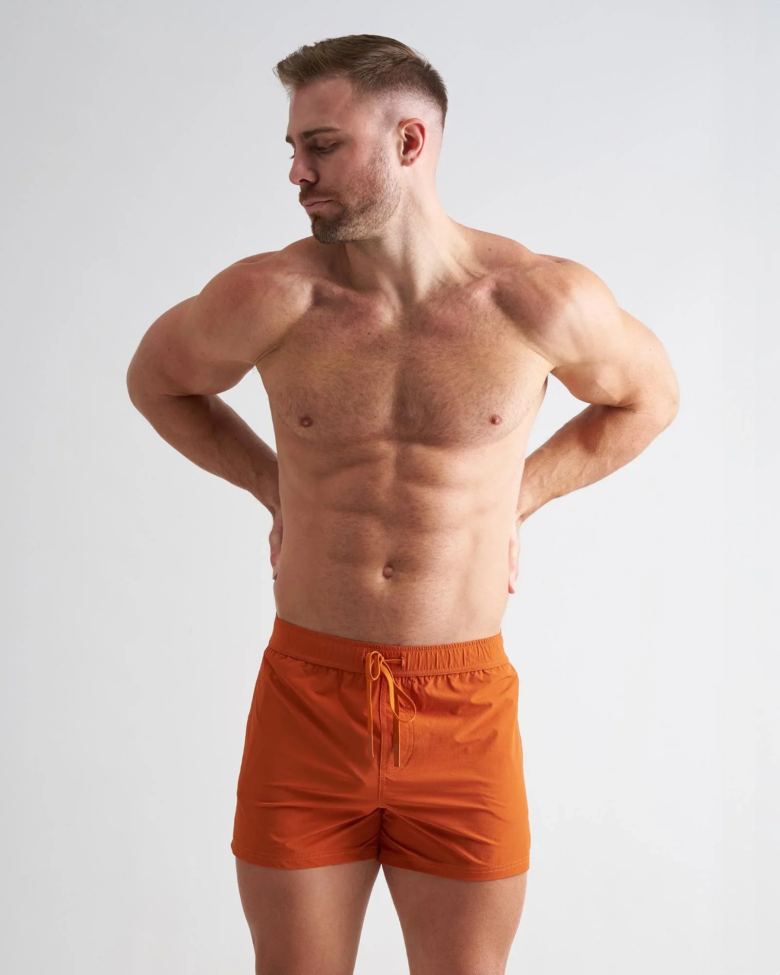 Orange bolt 3 inch athletic shorts with drawstring waistband made from lightweight breathable fabric for running