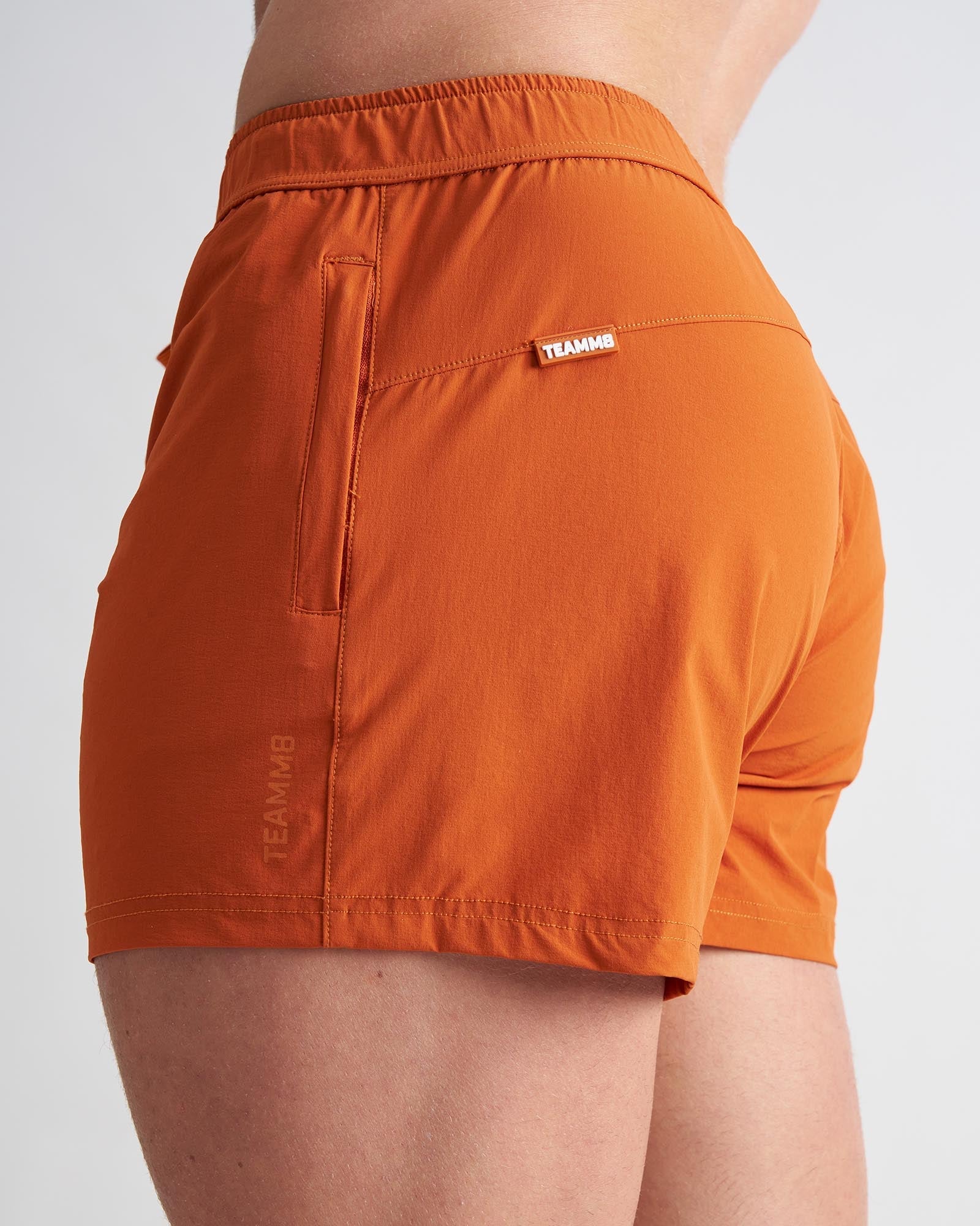 Orange bolt 3 shorts with fitted waistband and side pocket designed for athletic performance
