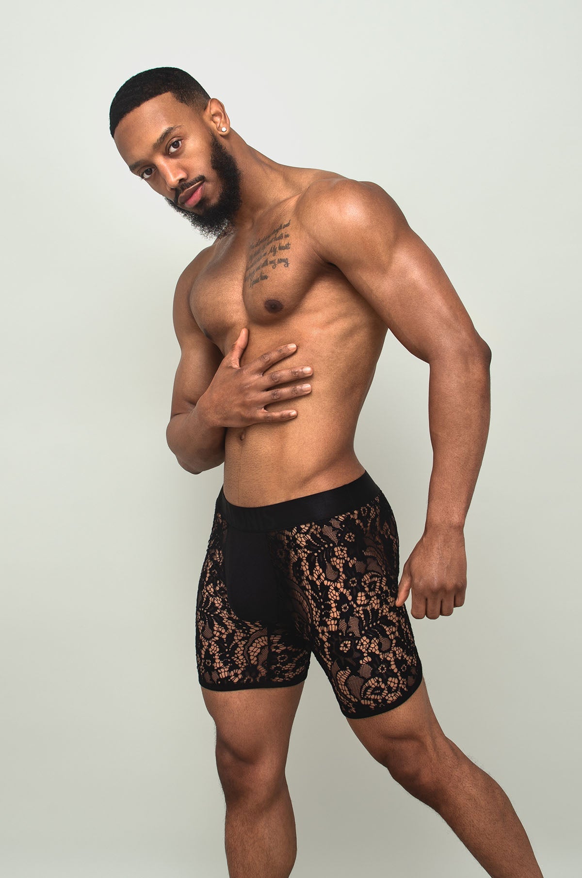 Black sheer lace boxer brief in black lace with intricate floral patterns shown from the front
