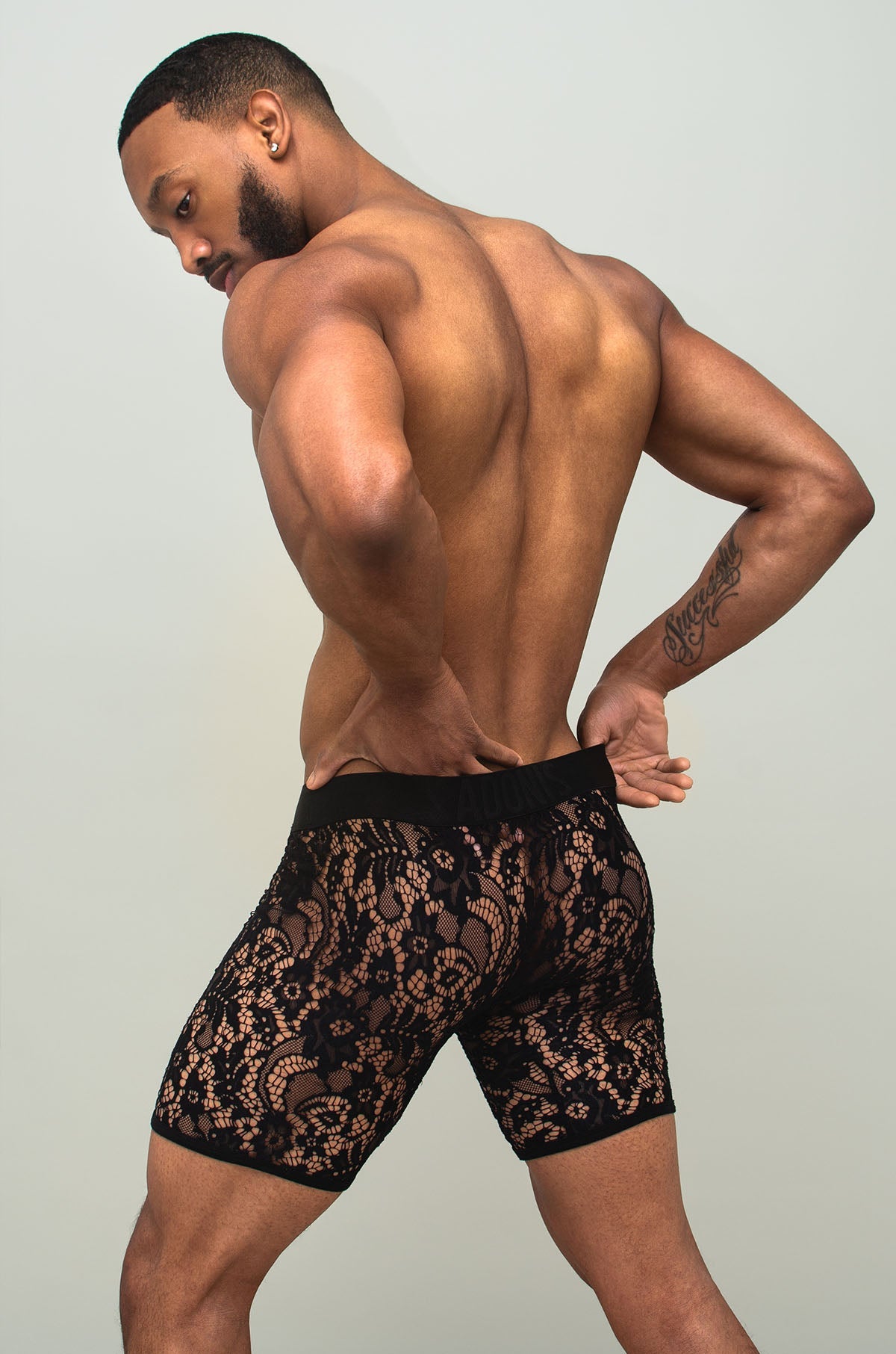 Black sheer lace boxer brief in black lace with a delicate intricate pattern visible in front side view