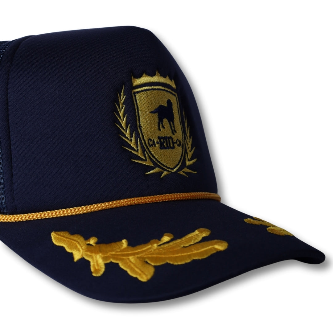 Navy blue ca-rio-ca captain trucker hat with gold embroidered shield emblem and oak leaf insignia