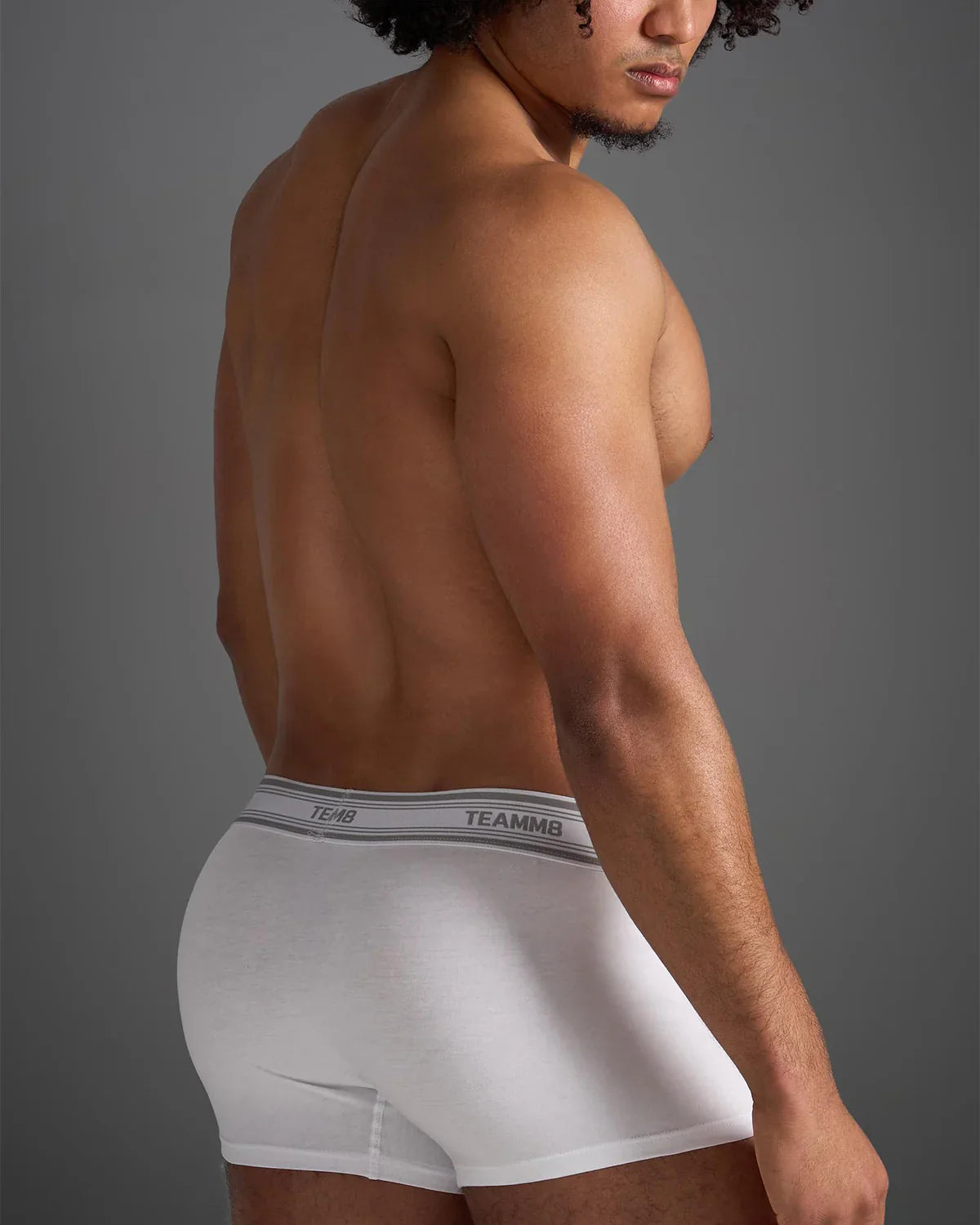 White classic cotton trunk boxer briefs with gray elastic waistband and black brand name lettering
