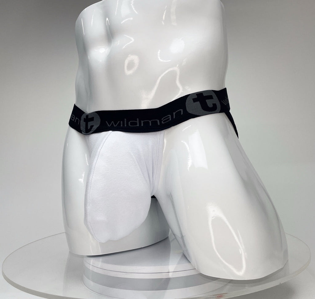 White WildmanT Big Boy pouch jockstrap on a glossy white mannequin, featuring a black branded waistband.