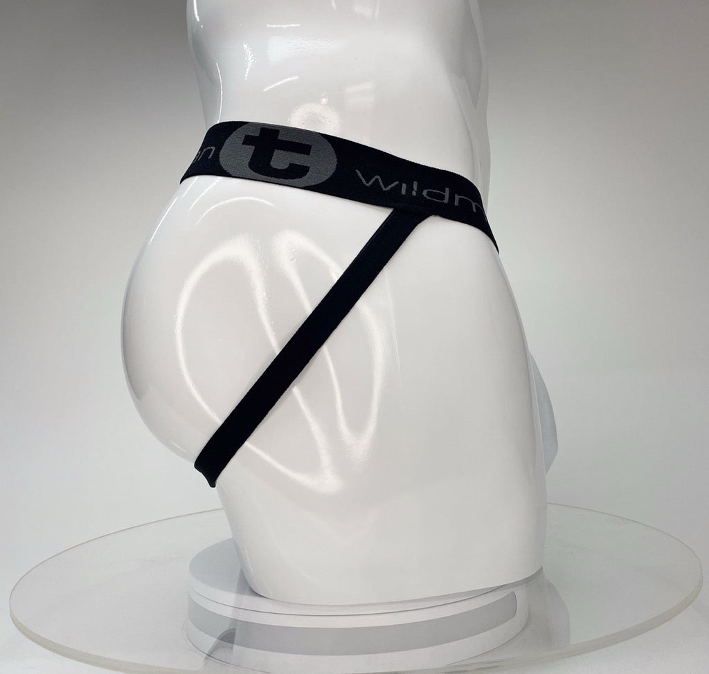 White WildmanT Big Boy jockstrap featuring a black waistband with gray logo text and branding on a white mannequin.