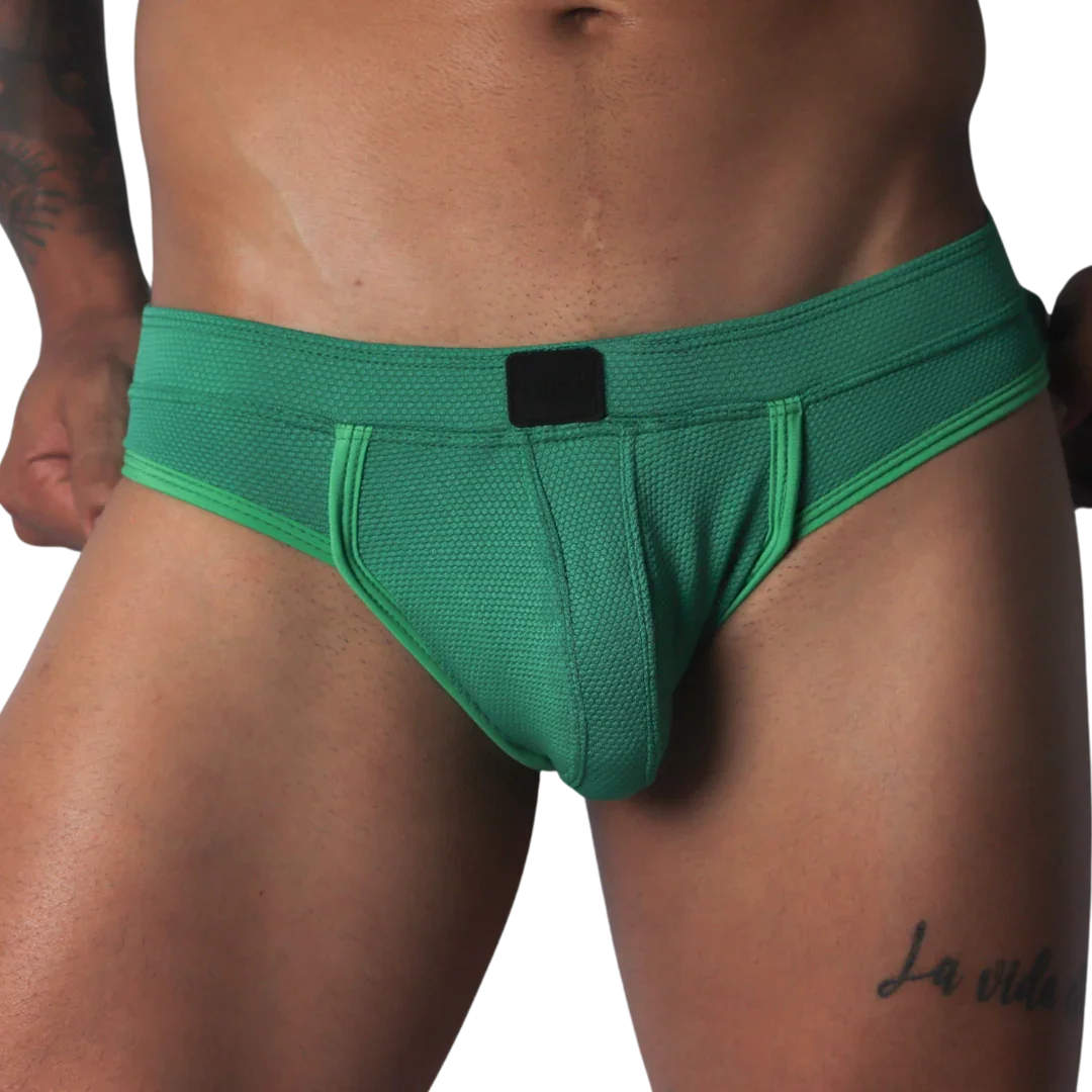 Green jockstrap featuring a textured honeycomb fabric, wide waistband, and a solid black central logo patch.
