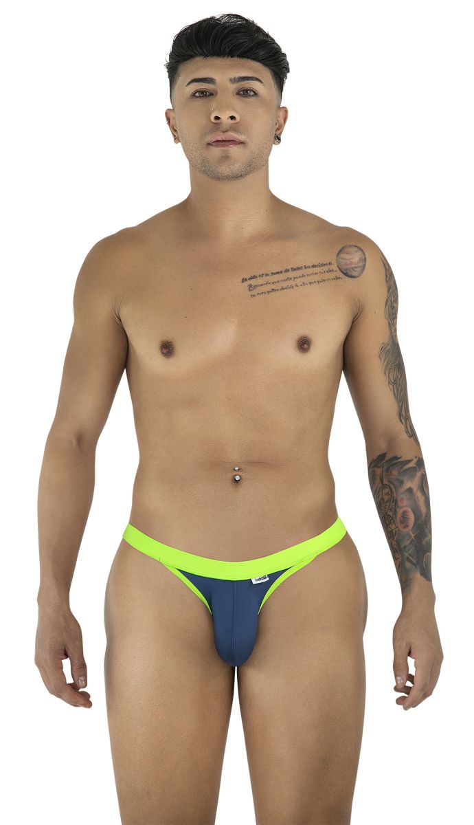 A model wearing a navy bikini with neon green trim, standing against a white background.