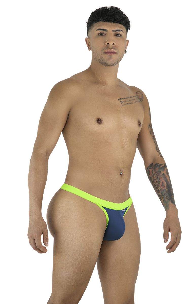 A man wearing a navy blue thong with neon green trim, standing in a profile pose.