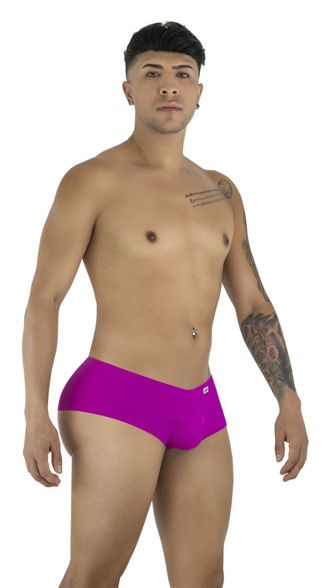 A man modeling magenta CandyMan trunks in a studio pose against a plain white background.