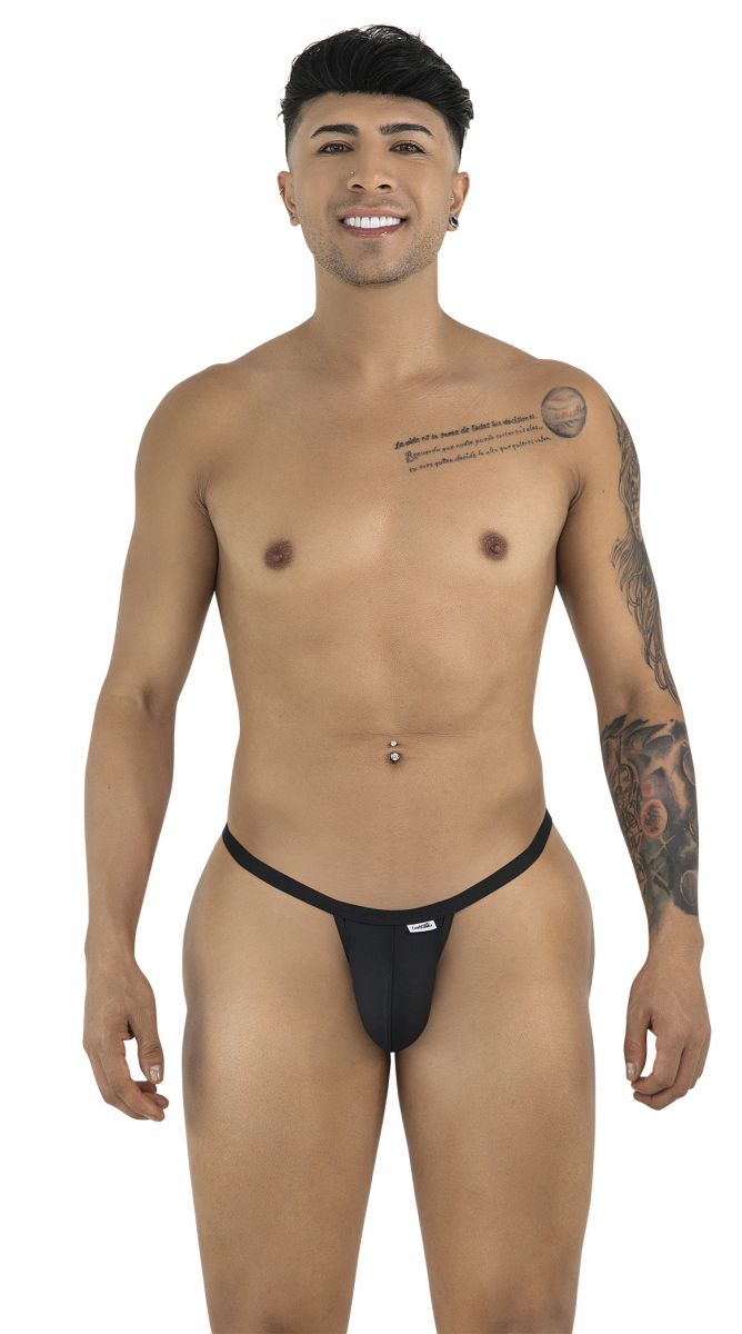 A smiling man with tattoos and a navel piercing models a minimalist black CandyMan thong against a white background.