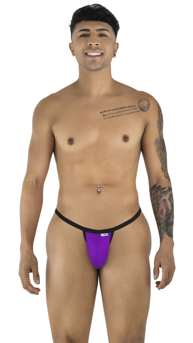 A man smiling, wearing an orchid-colored thong with thin black waistband straps against a white background.