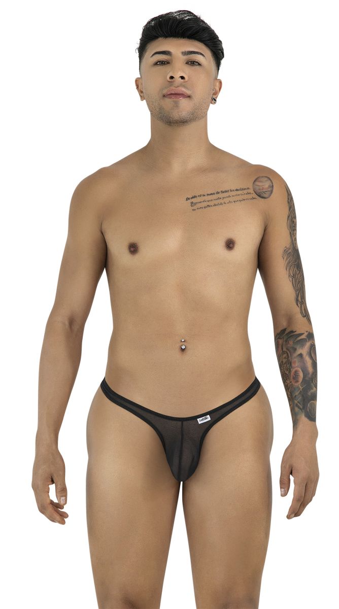 A man wearing black mesh CandyMan thongs, standing in a studio shot against a white background.