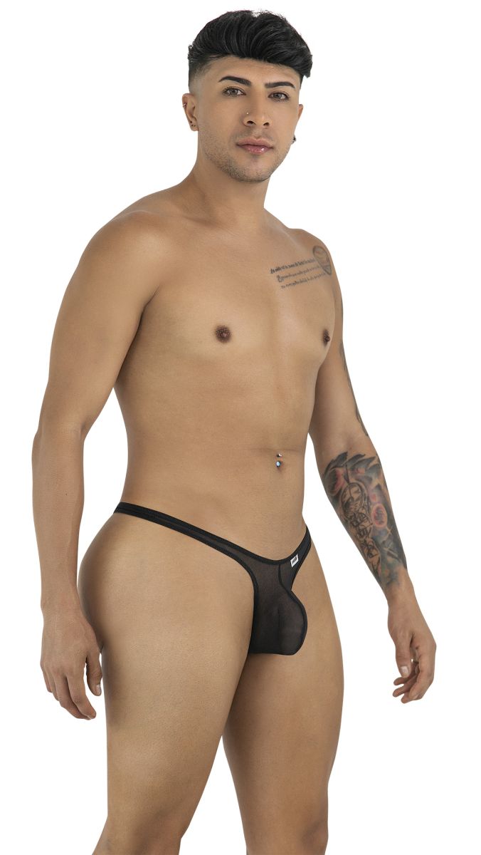 Model wearing a CandyMan black mesh thong, captured in a profile-facing studio pose against a white background.