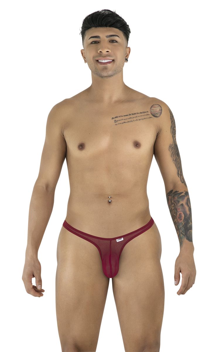Model wearing a burgundy mesh thong, standing against a white background.