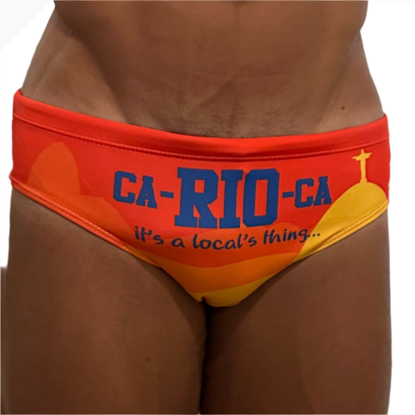 Vibrant orange and yellow swim trunks with bold blue ca-ri0-ca text and christ the redeemer graphic for carioca festival rio clearance final sales