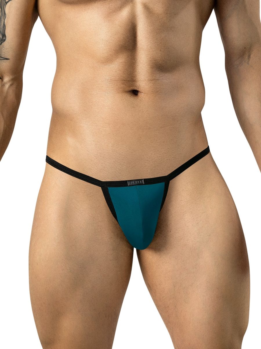 Front view of a model wearing petrol blue sleek thongs with black trim and a branded waistband.