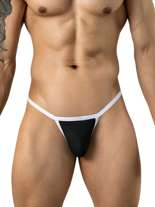 Front view of a model wearing black thong underwear with contrasting white trim and waistband.