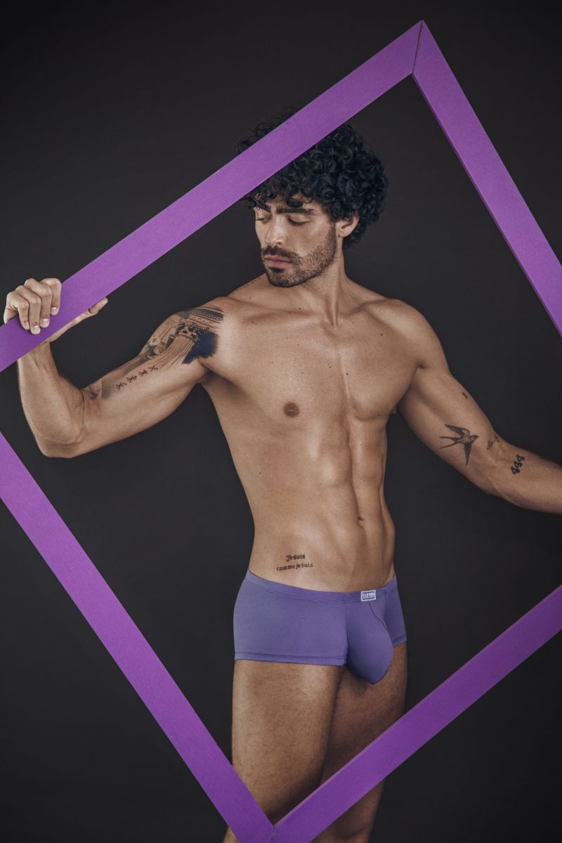 Lilac trunks worn by a person holding a purple frame.