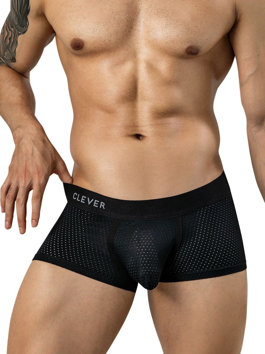 A person wearing black mesh trunks with a branded waistband.